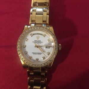 A 18k gold Rolex watch.